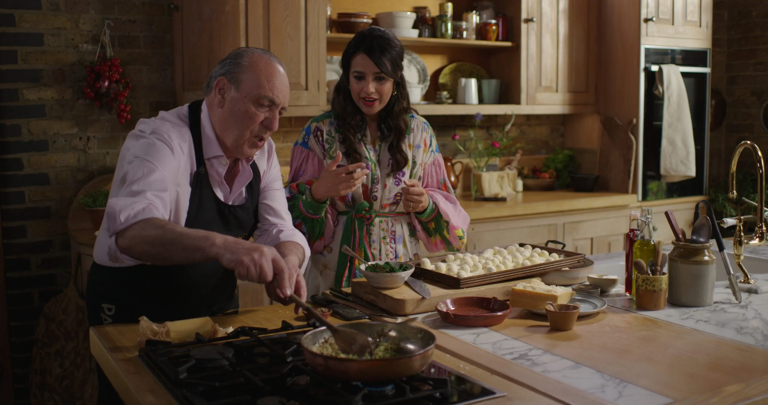 Gennaro Contaldo cooking with a woman